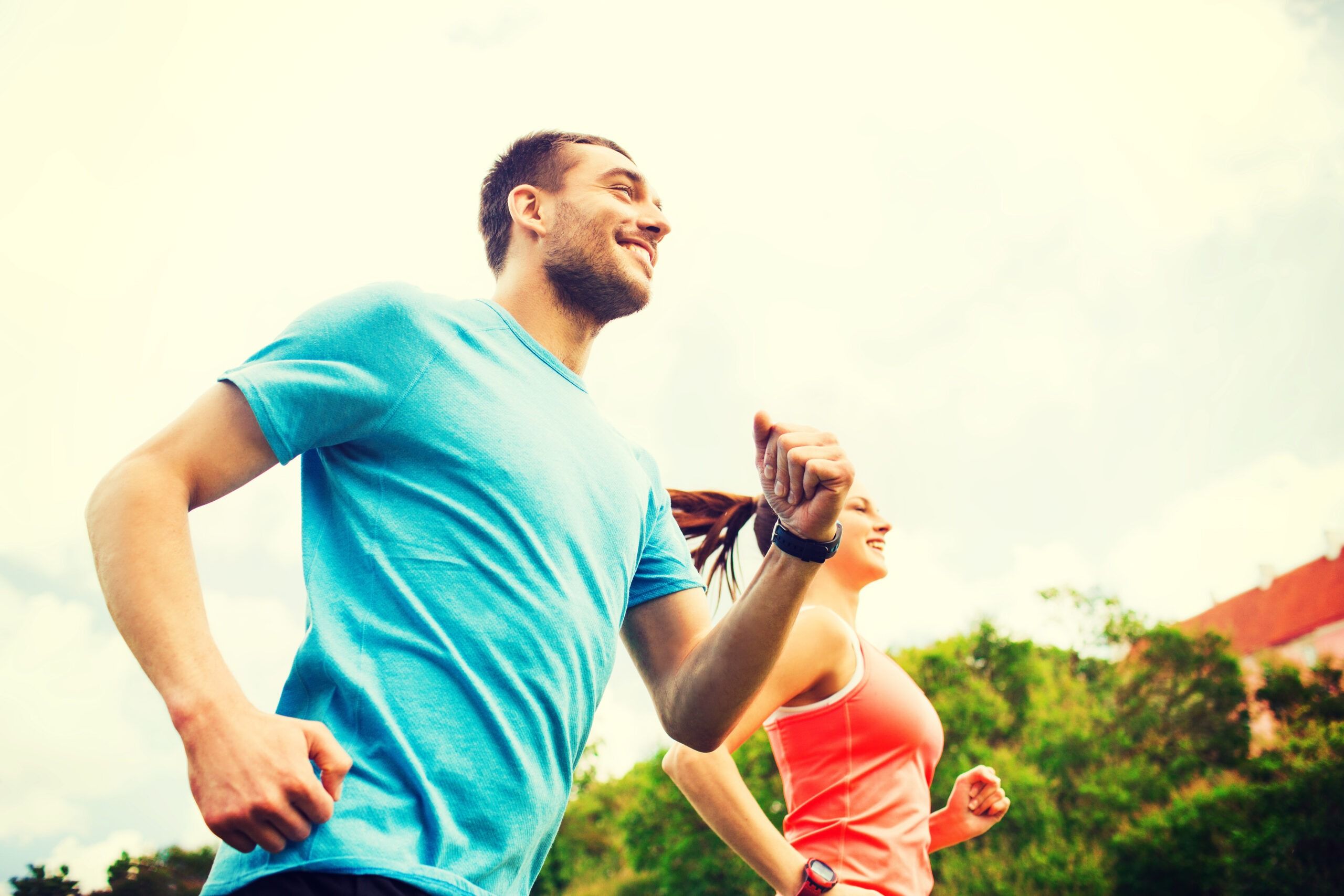 smiling couple running outdoors smiling couple running outdoors